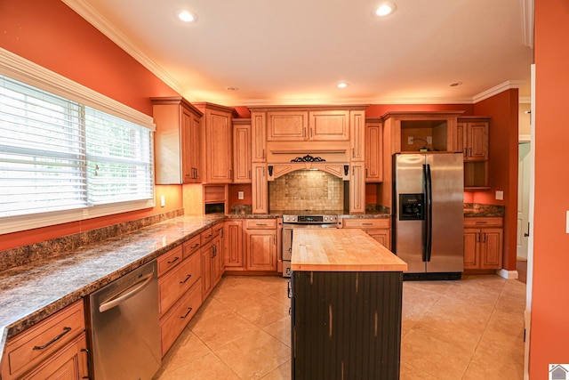 329 Royal Park Dr, Calvert City, KY 42029 - kitchen featuring appliances with stainless steel finishes, wooden counters, crown molding, light tile patterned floors, and premium range hood