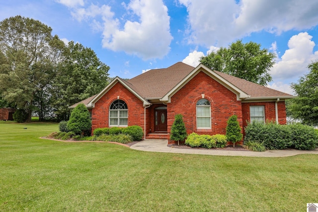 329 Royal Park Dr, Calvert City, KY 42029 - view of front facade with brick siding, a front lawn, and roof with shingles