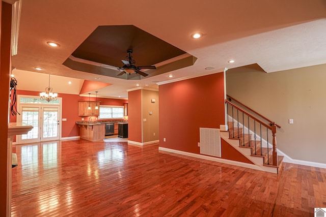 329 Royal Park Dr, Calvert City, KY 42029 - unfurnished living room with a ceiling fan, wood finished floors, a raised ceiling, a chandelier, and crown molding