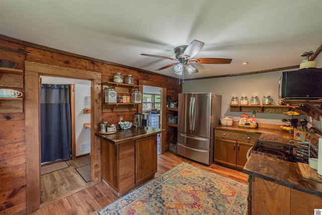 353 Creswell Rd, Princeton, KY 42445 - kitchen featuring freestanding refrigerator, open shelves, a ceiling fan, dark countertops, and wood walls