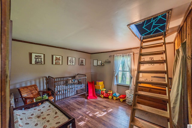 353 Creswell Rd, Princeton, KY 42445 - bedroom featuring wood finished floors, ornamental molding, and a crib