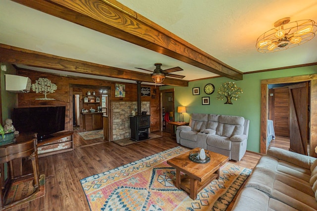 353 Creswell Rd, Princeton, KY 42445 - living area featuring a wood stove, wood finished floors, beamed ceiling, and ceiling fan