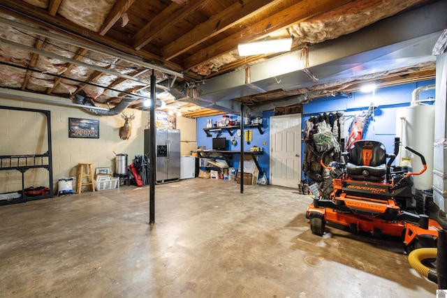 1333 Fairway Cir, Mayfield, KY 42066 - unfinished below grade area featuring stainless steel refrigerator with ice dispenser, concrete block wall, and gas water heater