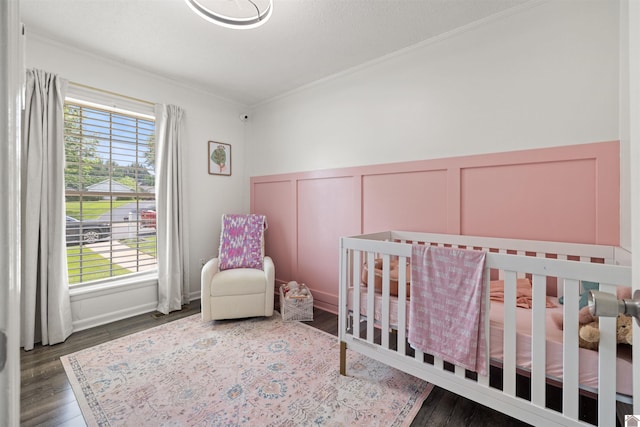 1333 Fairway Cir, Mayfield, KY 42066 - bedroom with ornamental molding, a decorative wall, a wainscoted wall, wood finished floors, and a crib