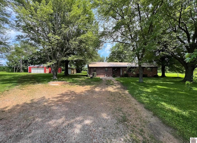 152 State Route 94 W, Sedalia, KY 42079 - view of front of house featuring dirt driveway, a front lawn, and an outdoor structure