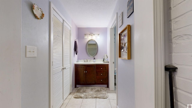 152 State Route 94 W, Sedalia, KY 42079 - bathroom featuring a closet, tile patterned flooring, vanity, and a textured ceiling