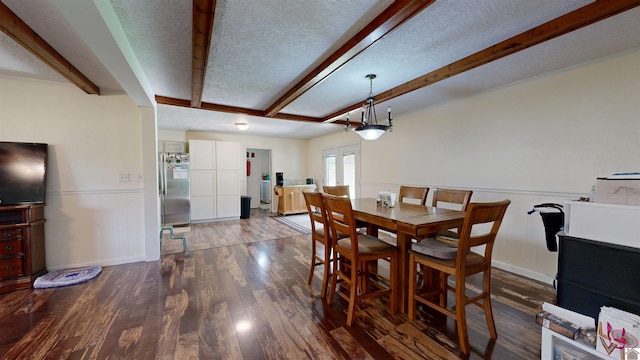 152 State Route 94 W, Sedalia, KY 42079 - dining space with beamed ceiling, dark wood-type flooring, a textured ceiling, and wainscoting