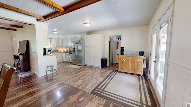 152 State Route 94 W, Sedalia, KY 42079 - kitchen featuring stainless steel appliances, light wood-style flooring, beam ceiling, white cabinetry, and wainscoting