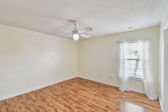 spare room with ceiling fan, light hardwood / wood-style flooring, and a textured ceiling