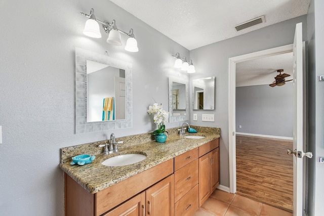 bathroom with vanity, a textured ceiling, tile patterned floors, and ceiling fan