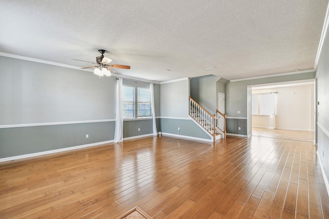 unfurnished room featuring hardwood / wood-style floors, crown molding, a textured ceiling, and ceiling fan