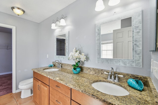 bathroom with vanity, toilet, and tile patterned flooring