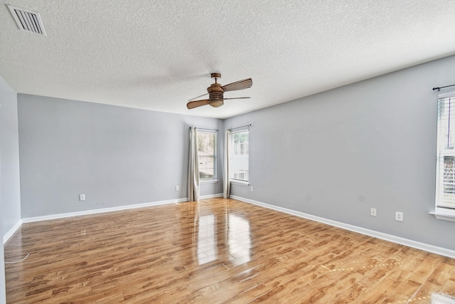 empty room featuring wood-type flooring, a textured ceiling, and ceiling fan