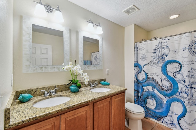 bathroom with walk in shower, toilet, a textured ceiling, vanity, and tile patterned flooring