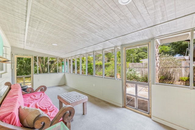 sunroom / solarium featuring vaulted ceiling