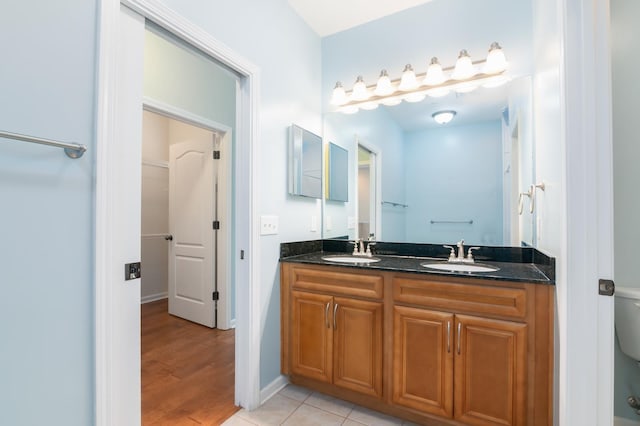 bathroom featuring vanity, toilet, and wood-type flooring