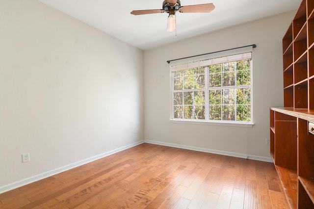 spare room with ceiling fan and hardwood / wood-style floors