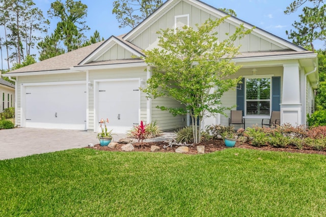 view of front of house with a front yard and a garage