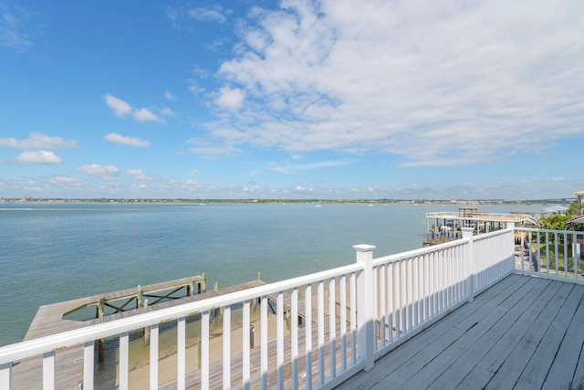 wooden deck with a water view and a dock