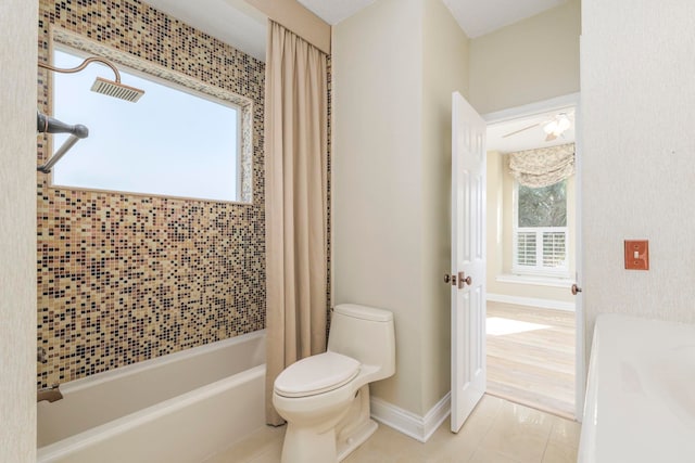 bathroom with tile patterned floors, shower / tub combo, and toilet