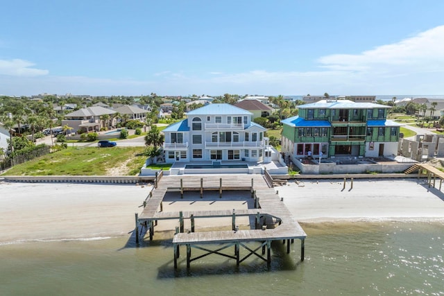 back of house featuring a view of the beach and a water view