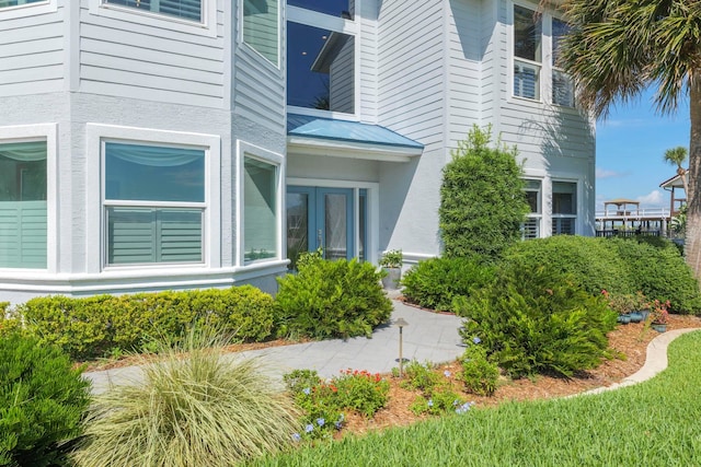 view of property exterior featuring french doors