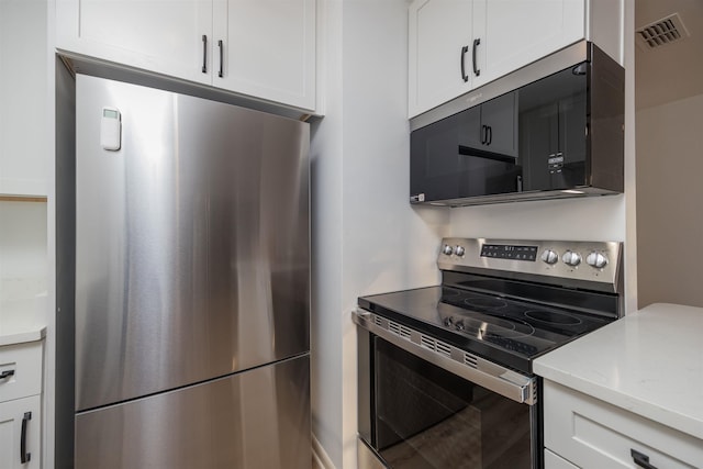 kitchen with appliances with stainless steel finishes and white cabinets