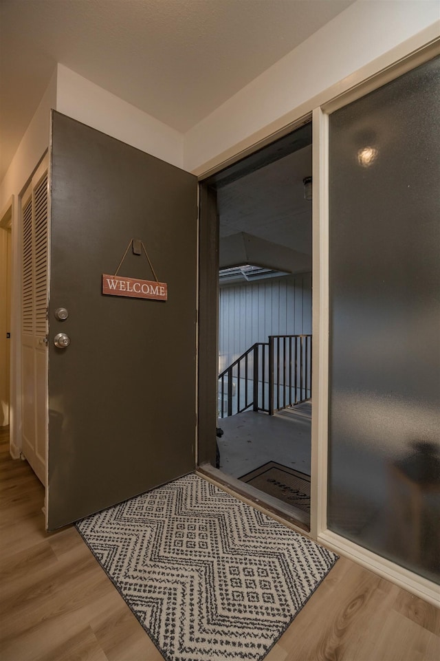 corridor with light hardwood / wood-style floors