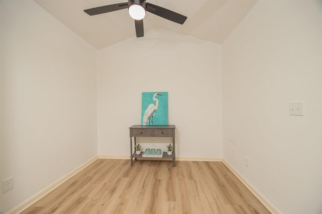 empty room with ceiling fan, lofted ceiling, and light hardwood / wood-style flooring