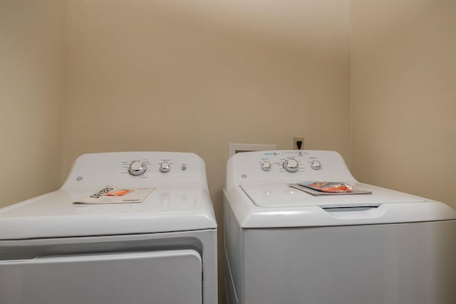 clothes washing area featuring washer and clothes dryer