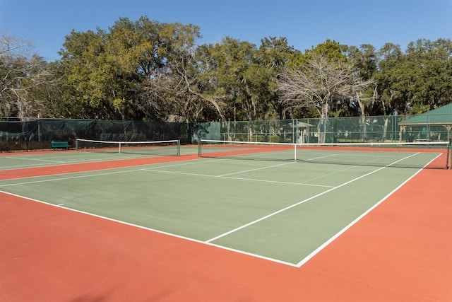 view of tennis court with basketball hoop