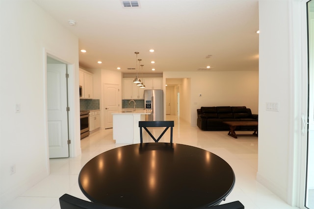 tiled dining space featuring sink