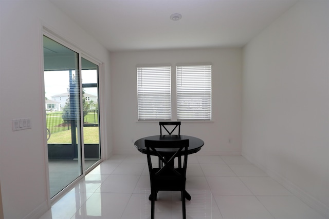 dining space with plenty of natural light and light tile patterned flooring