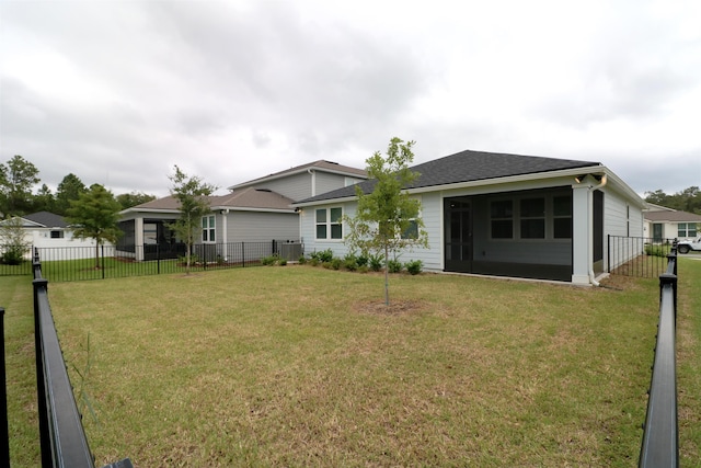 back of property featuring a lawn and central air condition unit