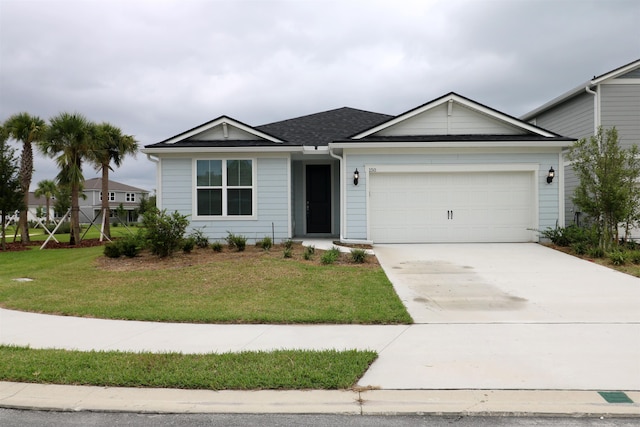 view of front of house featuring a front yard and a garage