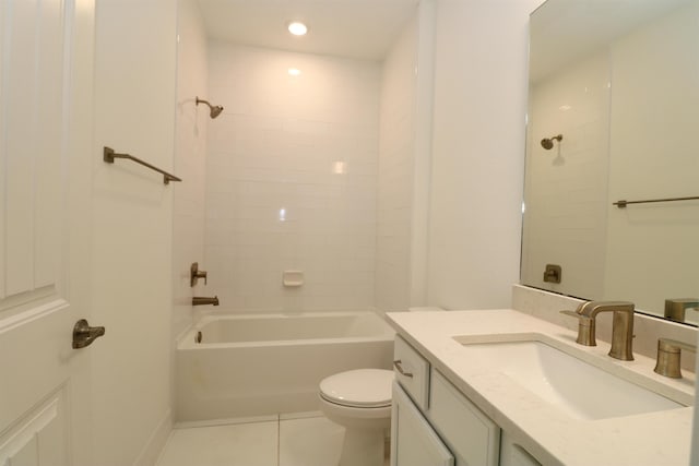 full bathroom with tile patterned floors, vanity, tiled shower / bath combo, and toilet