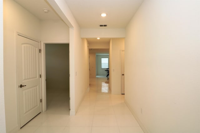 corridor featuring light tile patterned floors