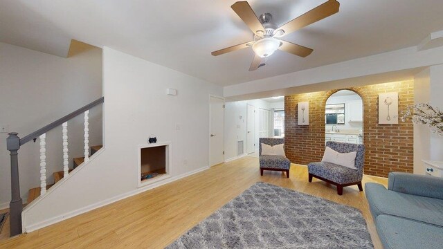 living room featuring ceiling fan and light wood-type flooring