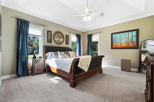 carpeted bedroom with ceiling fan and ornamental molding