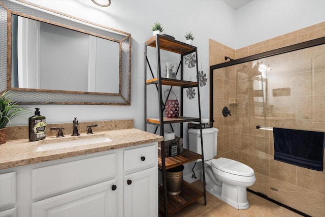 bathroom with tile patterned flooring, vanity, toilet, and a shower with shower door