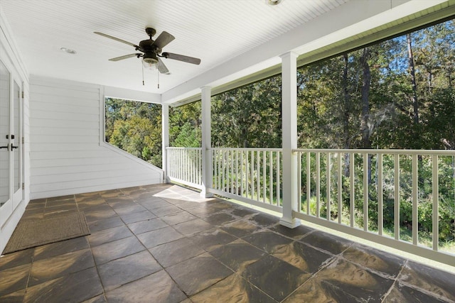 unfurnished sunroom with ceiling fan and a healthy amount of sunlight