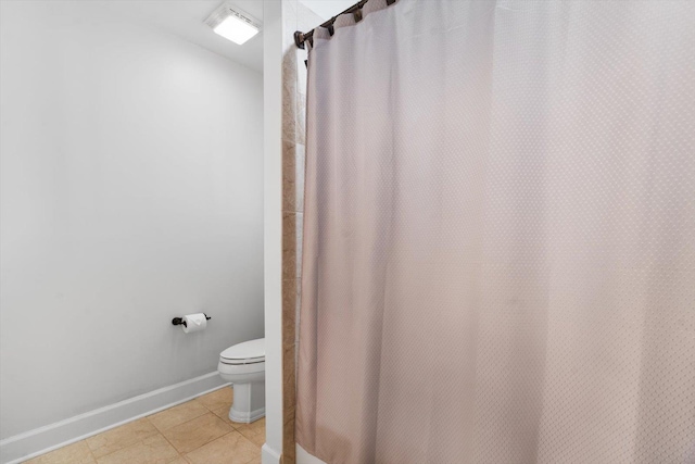 bathroom with tile patterned floors, walk in shower, and toilet