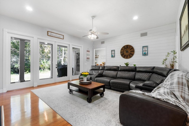 living room with ceiling fan, light hardwood / wood-style flooring, and french doors