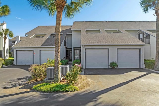 view of front of home with central AC and a garage