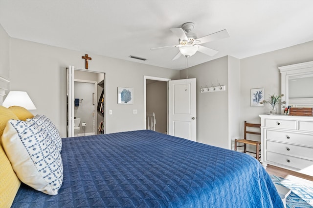 bedroom featuring hardwood / wood-style flooring, ceiling fan, and ensuite bathroom