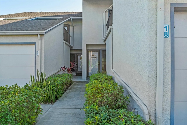 view of exterior entry with a garage