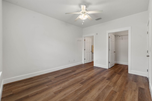 unfurnished bedroom with dark wood-type flooring, visible vents, and baseboards