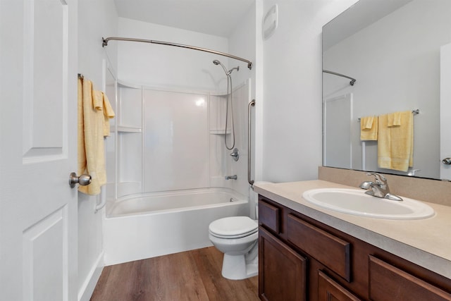 bathroom featuring toilet, shower / washtub combination, wood finished floors, and vanity