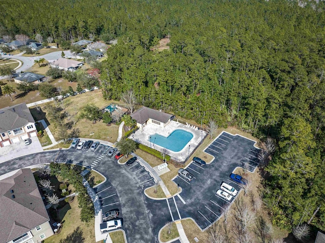 birds eye view of property featuring a view of trees