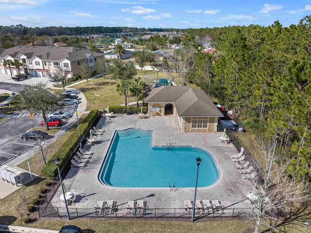 pool featuring a residential view, fence, and a patio